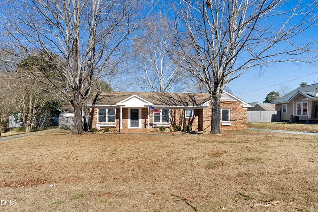 a backyard of a house with barbeque oven and outdoor seating