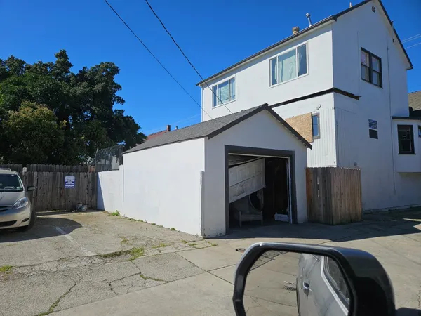 a view of a house with a car parked in front of a house