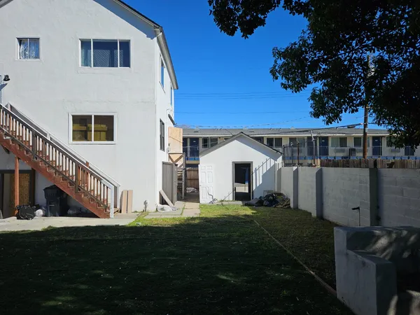 a view of house with yard and green space