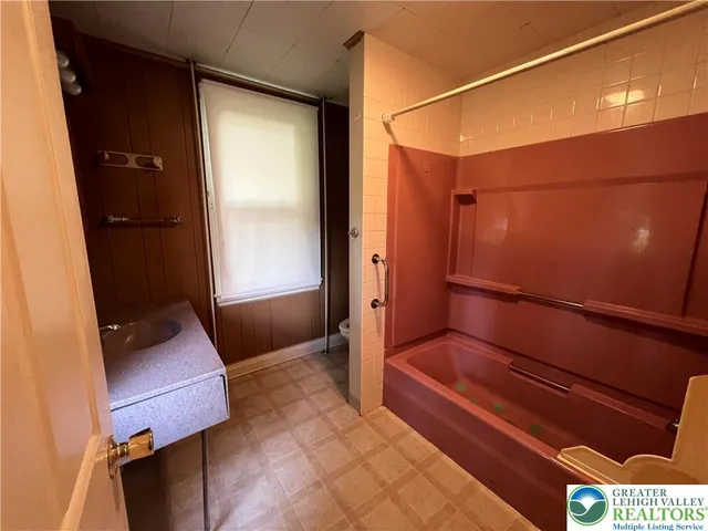 a bathroom with a bathtub and shower