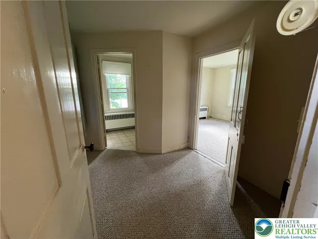 a view of an empty room with a fireplace