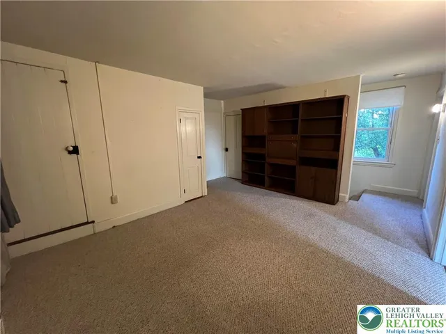 a view of an empty room with furniture and cabinet