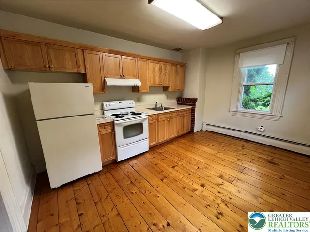 a kitchen with stainless steel appliances granite countertop a stove a sink dishwasher and a refrigerator