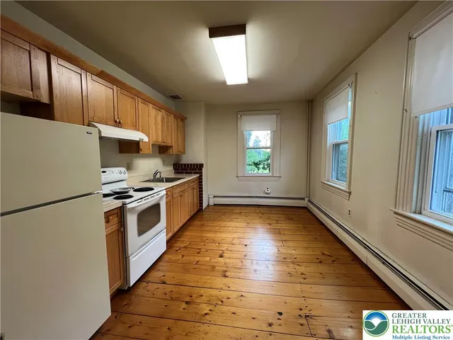 a kitchen with stainless steel appliances a refrigerator and a stove