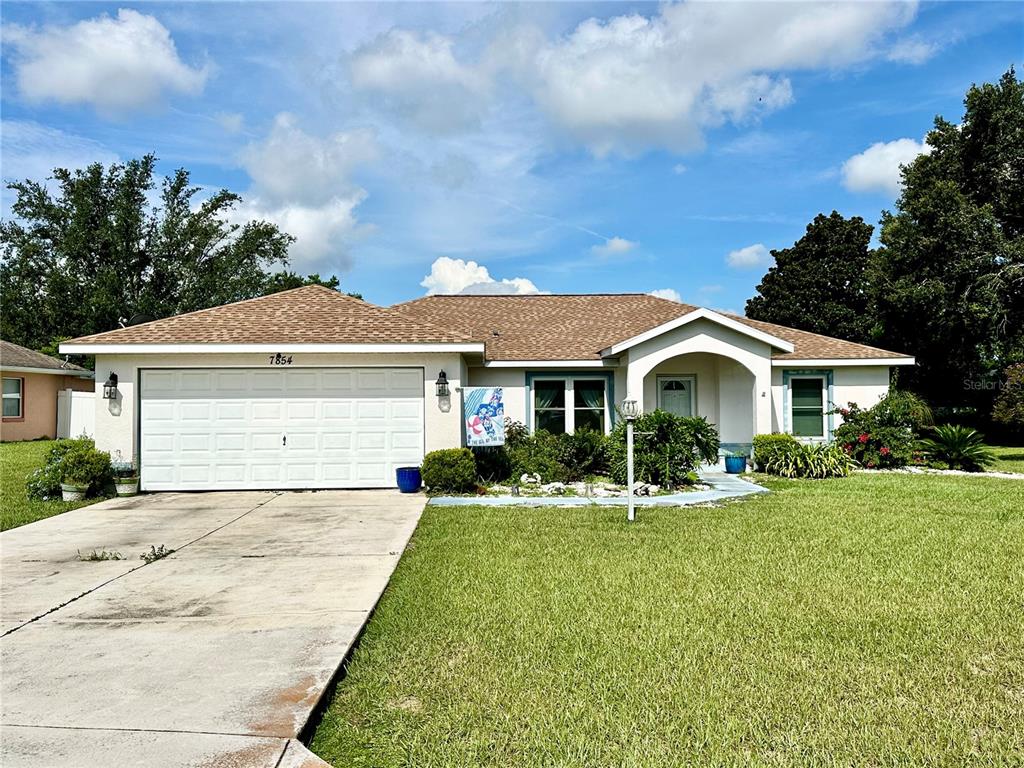 7854 Southwest 62nd Court Ocala, FL 34476 - Photo 1 of 1 a front view of house with yard and green space