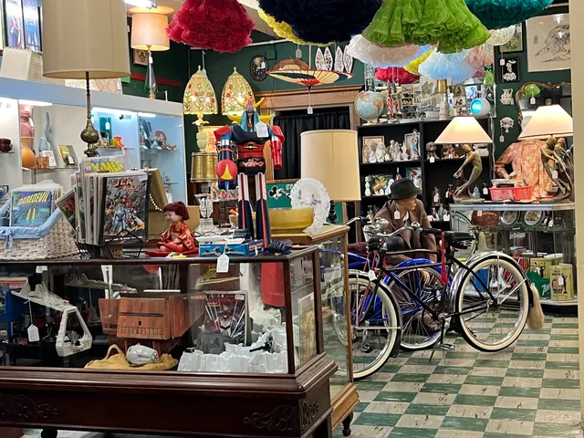 a kitchen with stainless steel appliances kitchen island granite countertop wooden cabinets and a stove