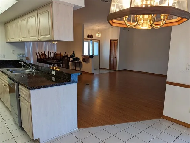 a kitchen with granite countertop a stove and a refrigerator