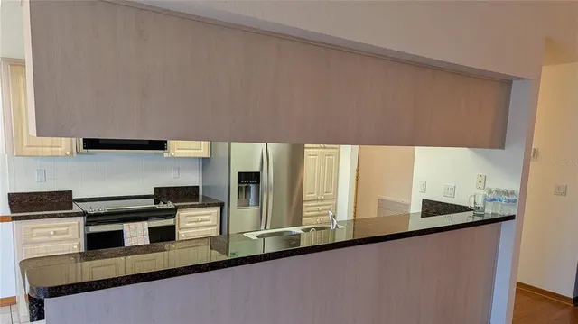 a kitchen with stainless steel appliances a sink a stove and a refrigerator