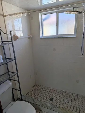 a bathroom with a toilet window and vanity