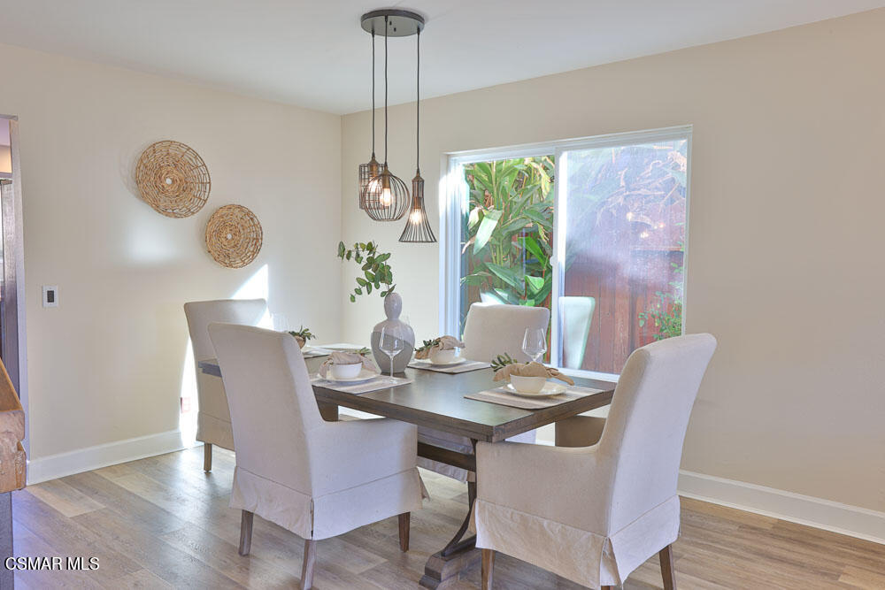 13520 Bear Valley Road Moorpark, CA 93021 - Photo 13 of 53 a dining room with furniture a chandelier and wooden floor