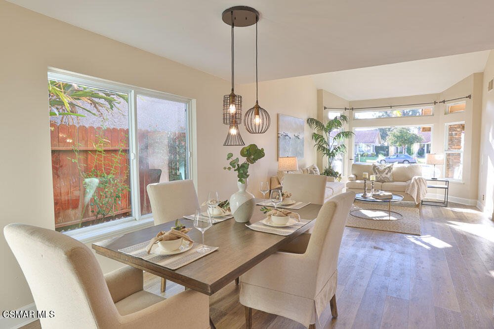 13520 Bear Valley Road Moorpark, CA 93021 - Photo 14 of 53 a dining room with furniture a chandelier and wooden floor