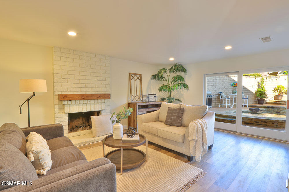 13520 Bear Valley Road Moorpark, CA 93021 - Photo 16 of 53 a living room with furniture and a fireplace