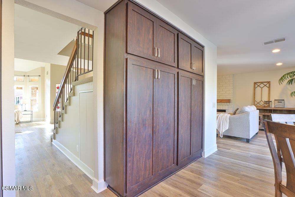 13520 Bear Valley Road Moorpark, CA 93021 - Photo 24 of 53 a view of a hallway with wooden floor stairs and a living room