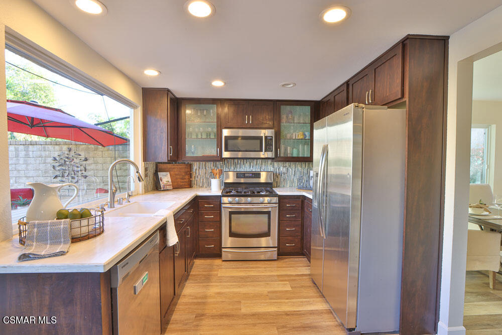13520 Bear Valley Road Moorpark, CA 93021 - Photo 25 of 53 a kitchen with stainless steel appliances a refrigerator sink and stove