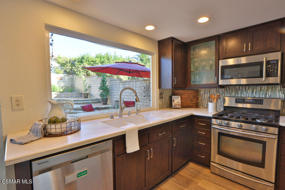 13520 Bear Valley Road Moorpark, CA 93021 - Photo 26 of 53 a kitchen with stainless steel appliances a sink stove and cabinets
