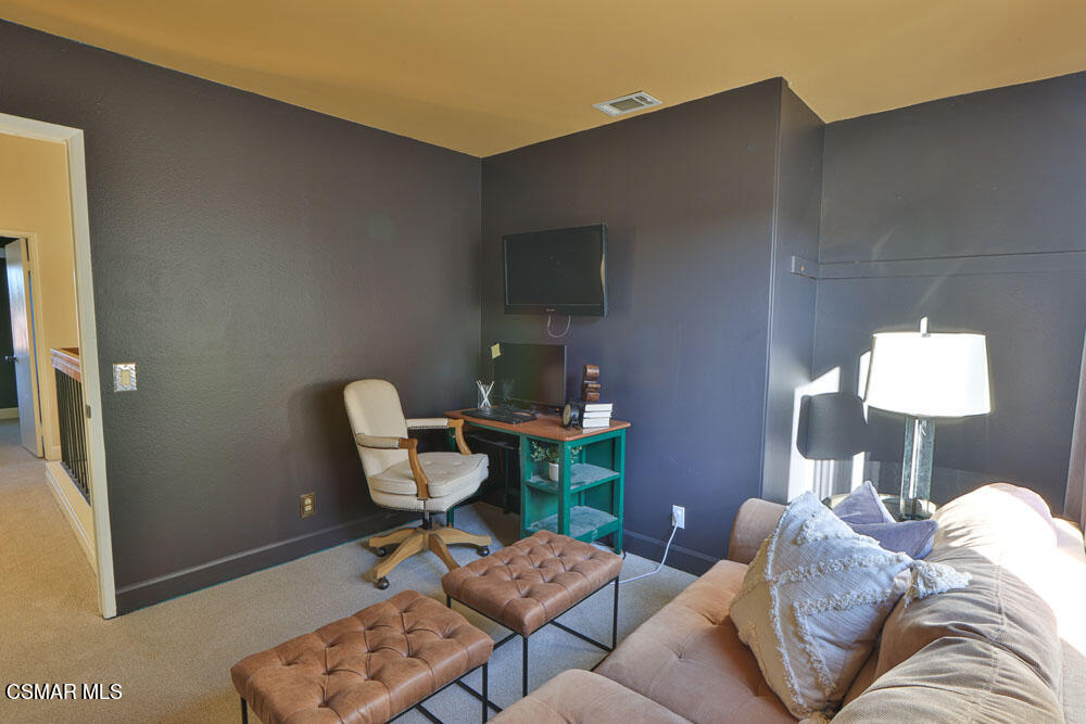13520 Bear Valley Road Moorpark, CA 93021 - Photo 36 of 53 a living room with furniture and a lamp