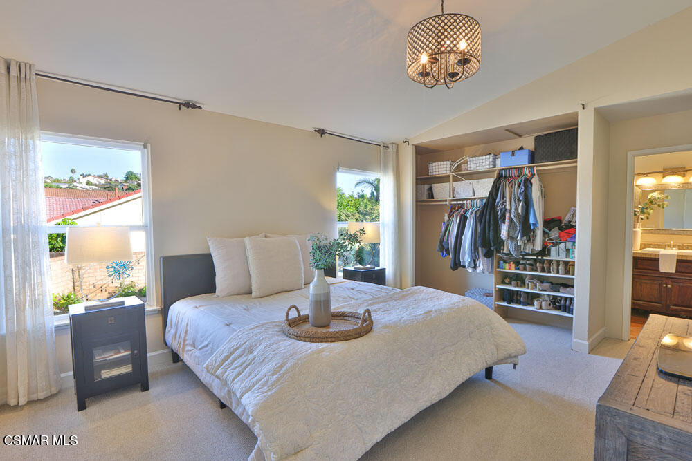 13520 Bear Valley Road Moorpark, CA 93021 - Photo 42 of 53 a bedroom with a bed and a chandelier