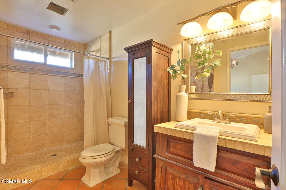 13520 Bear Valley Road Moorpark, CA 93021 - Photo 43 of 53 a bathroom with a sink a toilet and shower