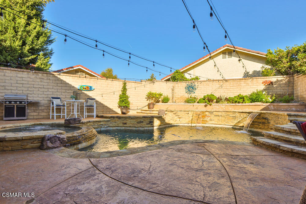13520 Bear Valley Road Moorpark, CA 93021 - Photo 47 of 53 a view of a house with a swimming pool