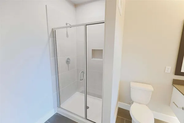 a bathroom with a shower and toilet