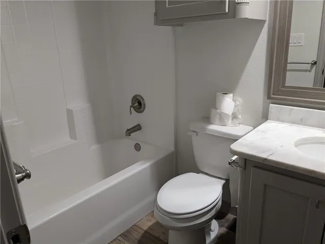 a view of a room with wooden floor and a window