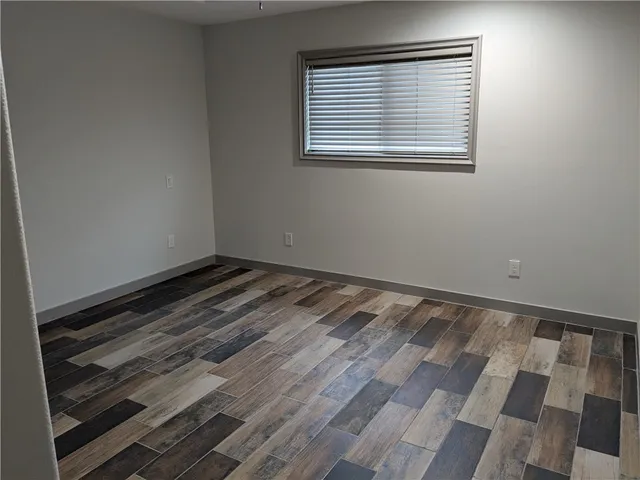 a bathroom with a granite countertop toilet sink and mirror