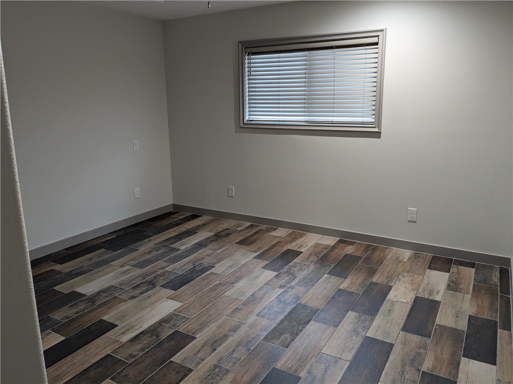 5375 County Road 73A, Unit D75 Robstown, TX 78380 - Photo 12 of 14 a view of a room with wooden floor and a window