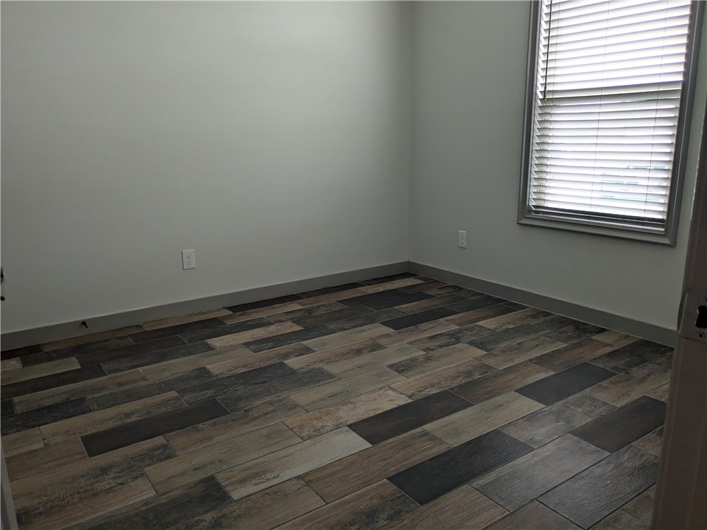 5375 County Road 73A, Unit D75 Robstown, TX 78380 - Photo 5 of 14 a view of a room with wooden floor and a window