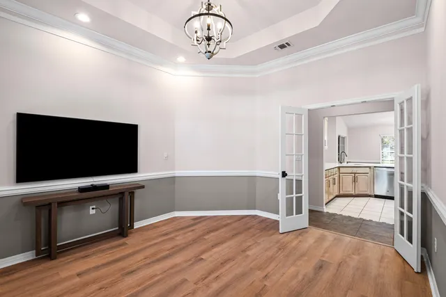 a view of an empty room with a fireplace and a window