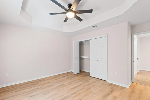 a bathroom with a granite countertop sink a toilet and a mirror