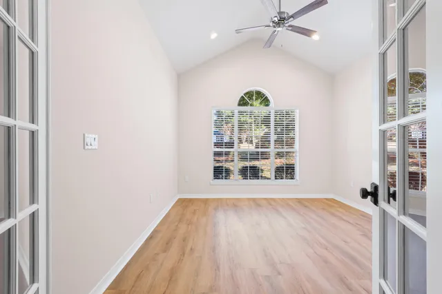 a view of a room with wooden floor and window