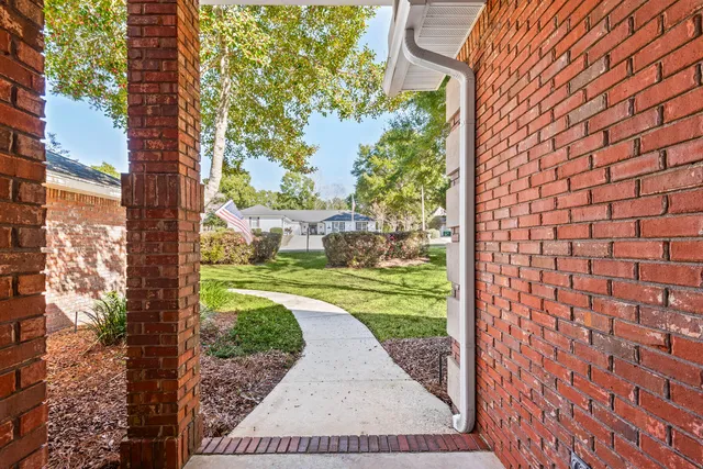 a view of a back yard from a brick wall