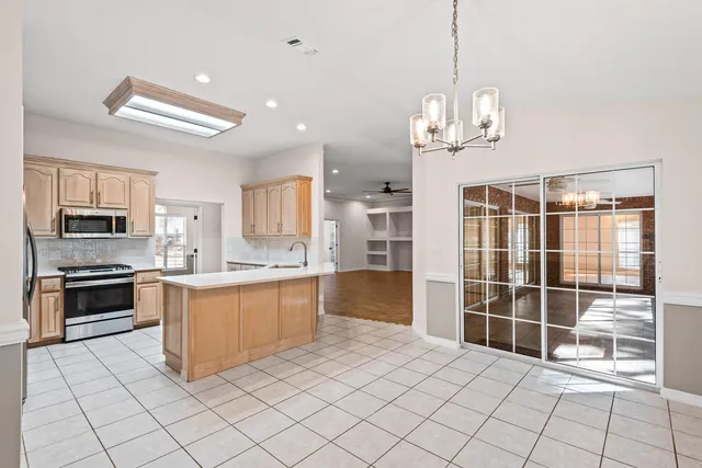 a kitchen with stainless steel appliances granite countertop a refrigerator oven a stove top oven a sink and dishwasher