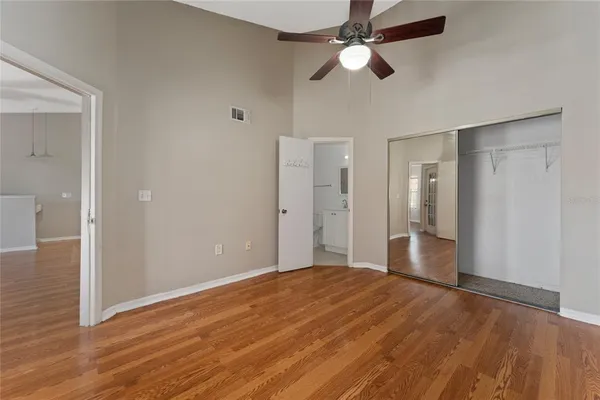 a view of empty room with wooden floor