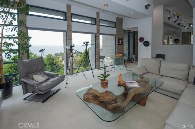 a living room with furniture and a floor to ceiling window