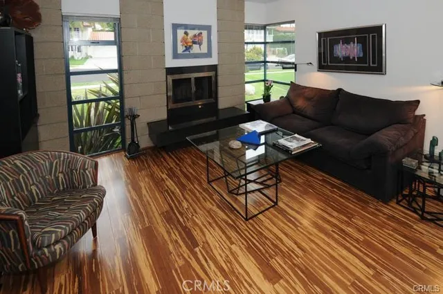 a living room with furniture fireplace and a window