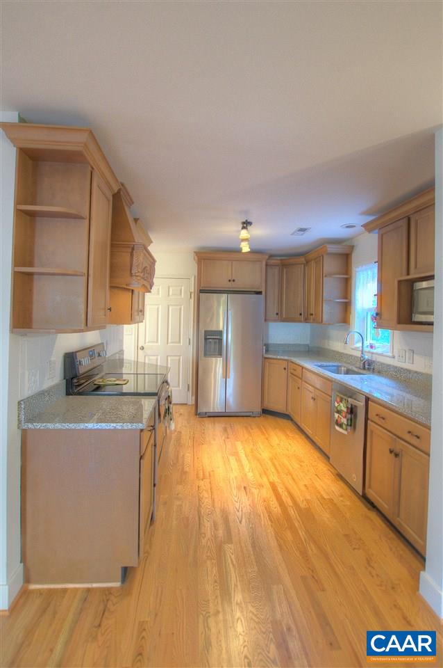 4865 Mechums River Road Charlottesville, VA 22901 - Photo 11 of 45 a kitchen with stainless steel appliances granite countertop a sink stove and refrigerator