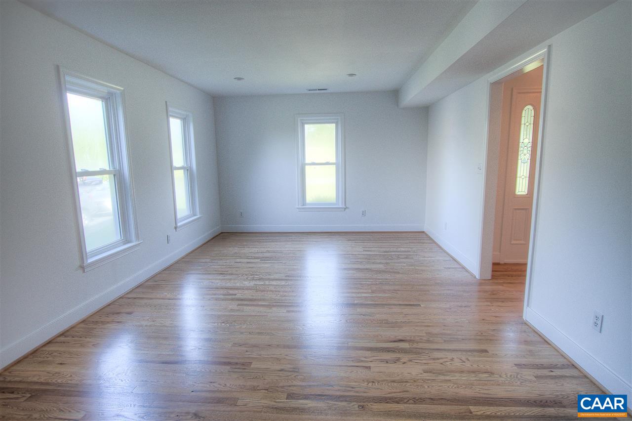 4865 Mechums River Road Charlottesville, VA 22901 - Photo 21 of 45 an empty room with wooden floor and windows