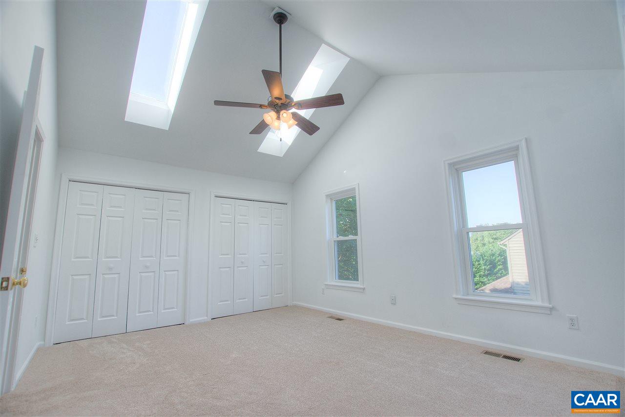 4865 Mechums River Road Charlottesville, VA 22901 - Photo 22 of 45 an empty room with windows and fan