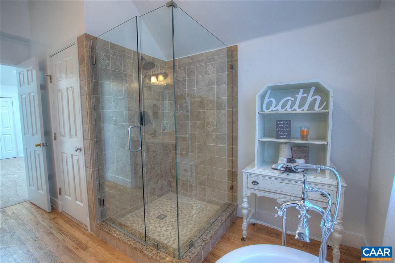4865 Mechums River Road Charlottesville, VA 22901 - Photo 25 of 45 a bathroom that has a glass shower door