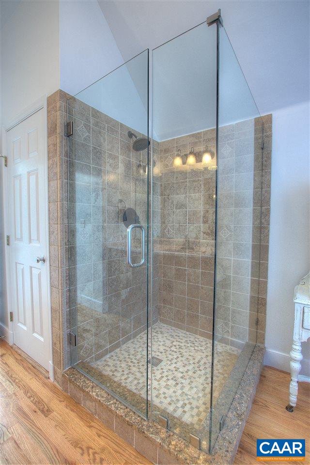 4865 Mechums River Road Charlottesville, VA 22901 - Photo 26 of 45 a bathroom that has a glass shower door