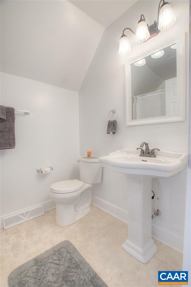 4865 Mechums River Road Charlottesville, VA 22901 - Photo 32 of 45 a bathroom with a sink a toilet and a mirror