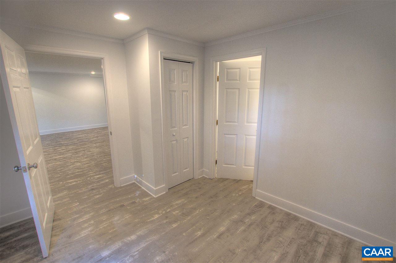 4865 Mechums River Road Charlottesville, VA 22901 - Photo 45 of 45 wooden floor in an empty room with a bathroom