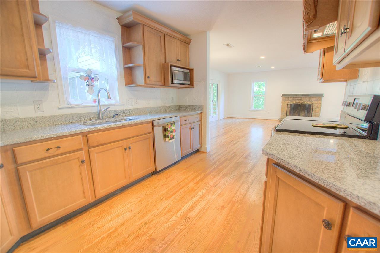 4865 Mechums River Road Charlottesville, VA 22901 - Photo 9 of 45 a large kitchen with stainless steel appliances granite countertop a sink and dishwasher stove with wooden floor