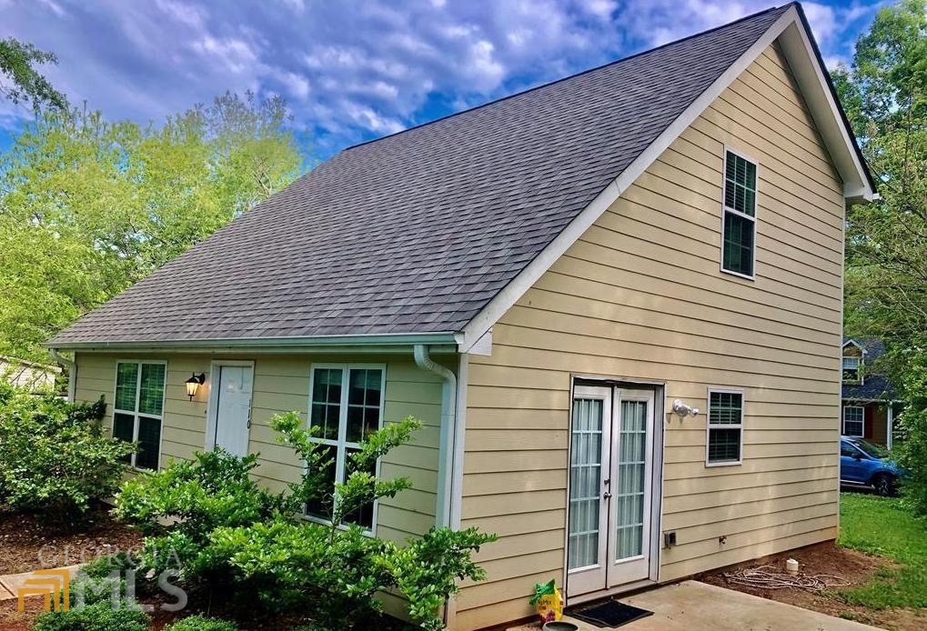 a view of a house with potted plants