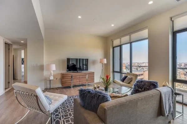 a bedroom with furniture and a large window