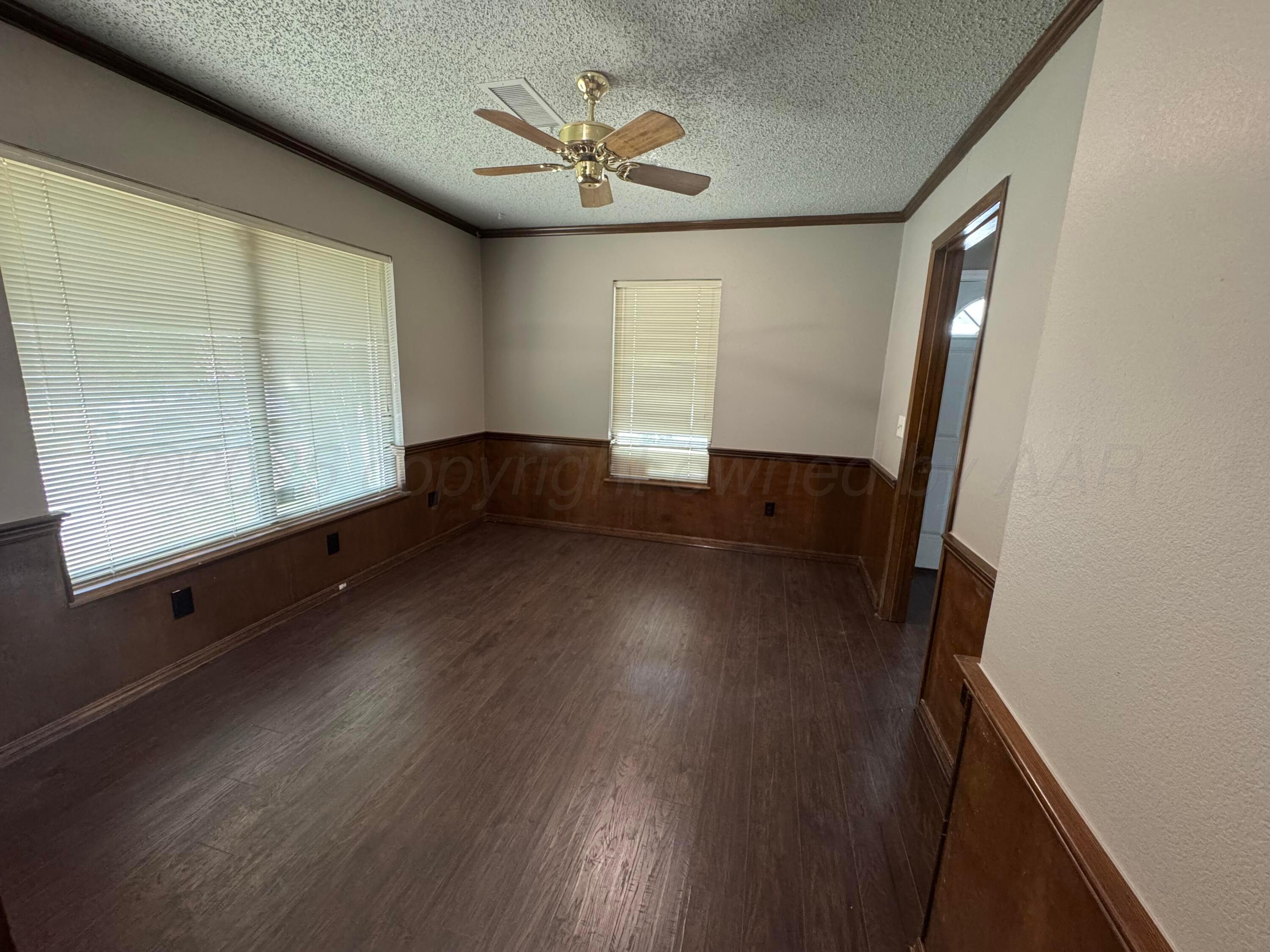 1022 Southwest 15th Avenue Amarillo, TX 79102 - Photo 11 of 11 a view of an empty room with wooden floor and a window