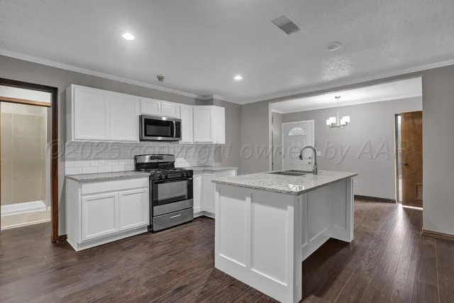 a kitchen with a stove sink and a refrigerator