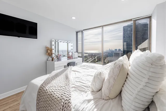 a bed sitting in a bedroom next to a window