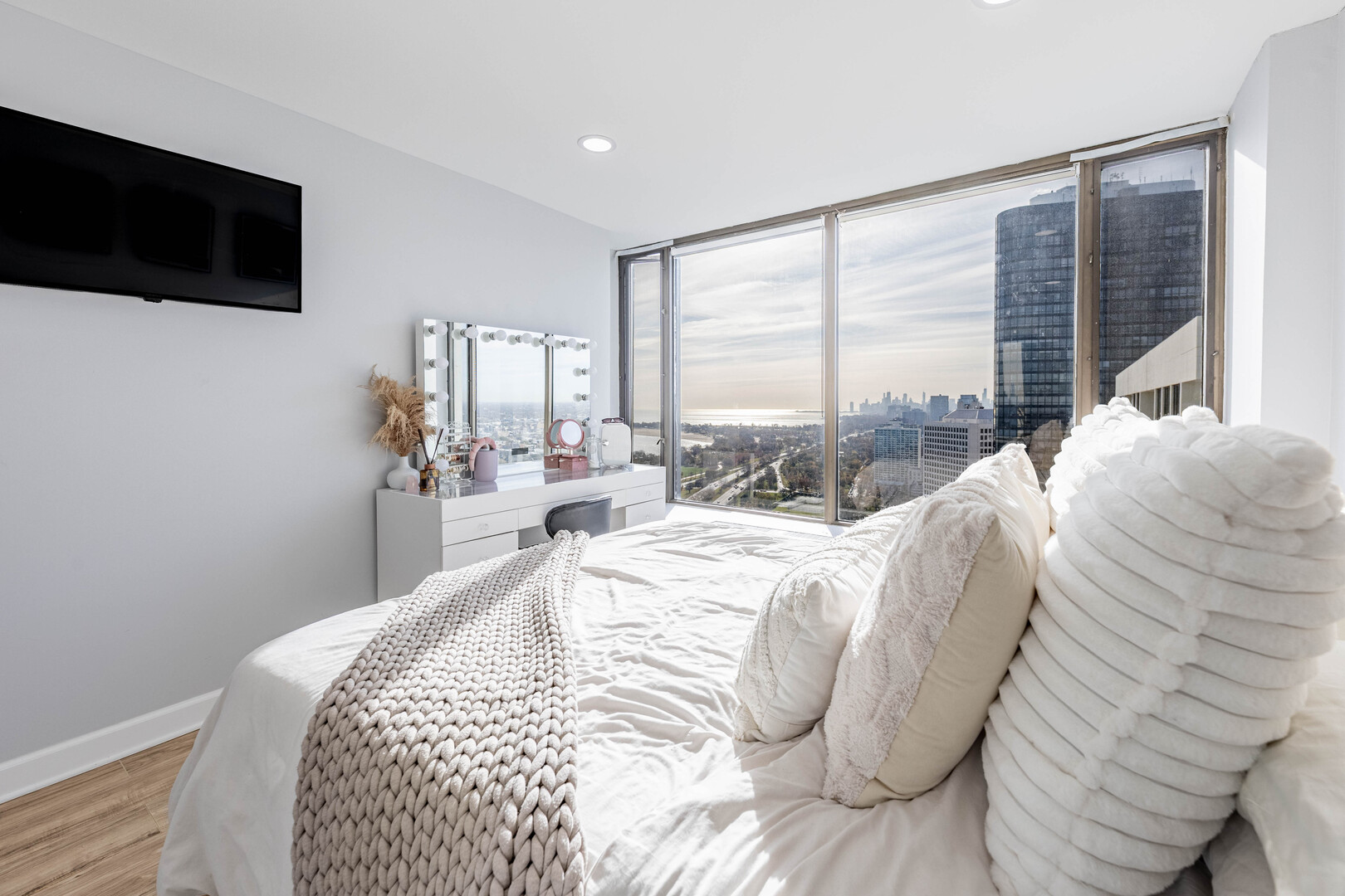 5455 North Sheridan Road, Unit 3906 Chicago, IL 60640 - Photo 11 of 28 a bed sitting in a bedroom next to a window